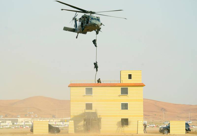 Soldiers descend from a helicopter to enter a building occupied by "terrorists" during one of the military exercises on Saturday. Wam