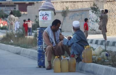 People sell petrol on a roadside in Kabul. EPA