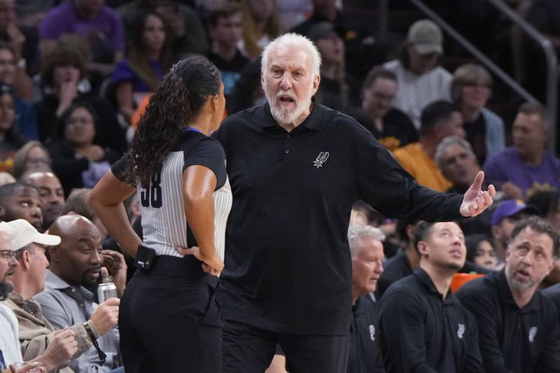 San Antonio Spurs coach Gregg Popovich talks to official Sha'Rae Mitchell during the second half of the team's game against the Phoenix Suns. AP