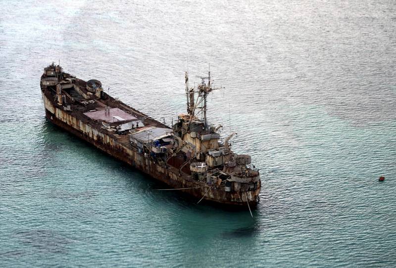 Filipino soldiers wave from the dilapidated 'Sierra Madre' ship of the Philippine Navy in the South China Sea, west of Palawan, Philippines, in 2015. Photo: Reuters