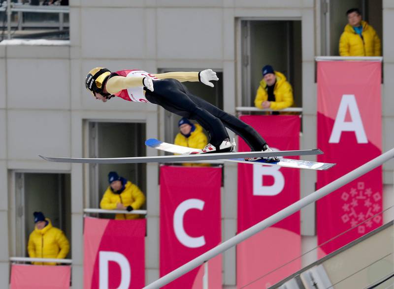 Lukas Klapfer, of Austria, soars through the air during the competition jump in the nordic combined event at the 2018 Winter Olympics in Pyeongchang. Dmitri Lovetsky / AP Photo