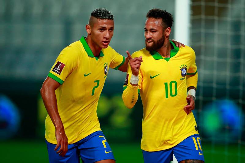 Neymar celebrates with teammate Richarlison after scoring a penalty. AFP