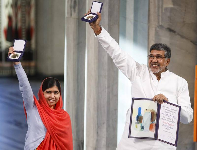 Nobel Peace Prize winners Malala Yousafzai from Pakistan and Kailash Satyarthi of India hold up their Nobel Peace Prize during the award ceremony in Oslo, Norway on December 10, 2014.  Heiko Junge/AP Photo