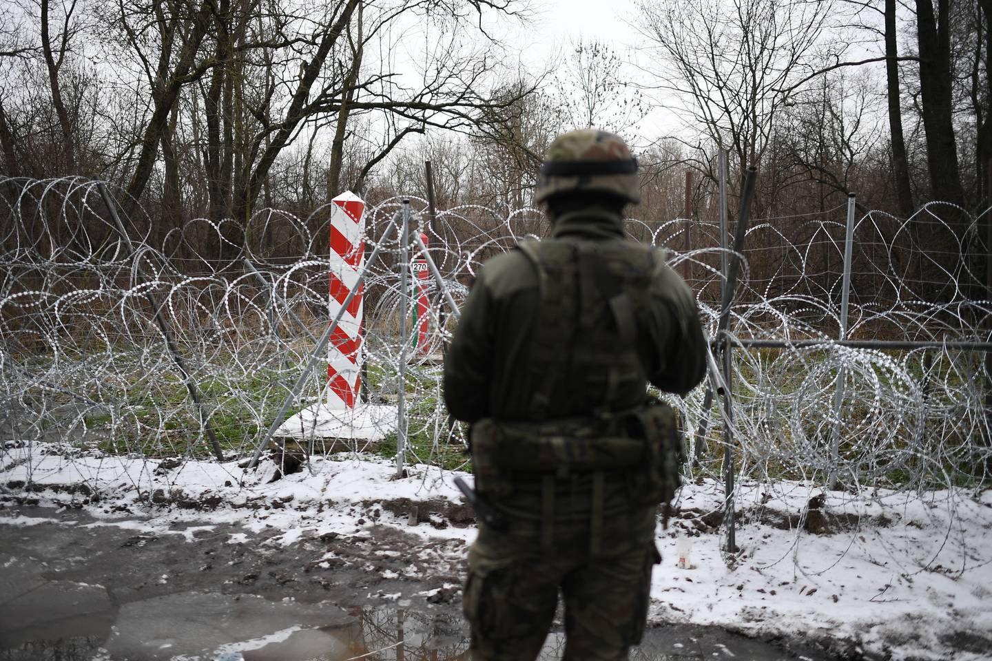 A Polish soldier at the border with Belarus, where at least 13 people are thought to have died since the crisis erupted. EPA 