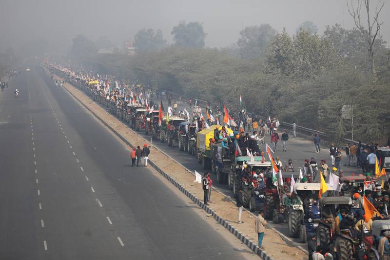 Farmers in large numbers take part in a 'parallel parade' on tractors and trolleys, during their ongoing farmers protest against the new agricultural laws, on the outskirts of New Delhi. EPA