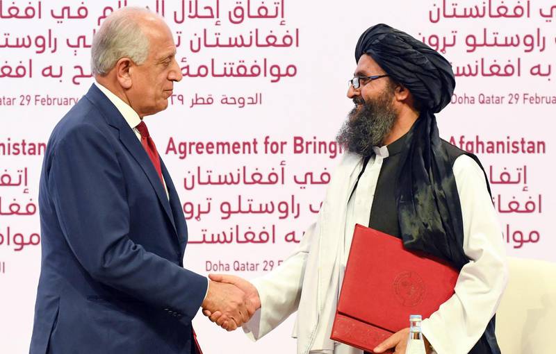 epa08261626 US Special Representative for Afghanistan Reconciliation Zalmay Khalilzad (L) and Taliban co-founder Mullah Abdul Ghani Baradar shake hands during the signing ceremony of the US-Taliban peace agreement in Doha, Qatar, 29 February 2020 (issued 01 March 2020). The United States and the Taliban on 29 February penned a historic Agreement to Bringing Peace to Afghanistan which paves the way for the withdrawal of US troops and intra-Afghan negotiations.  EPA/STRINGER