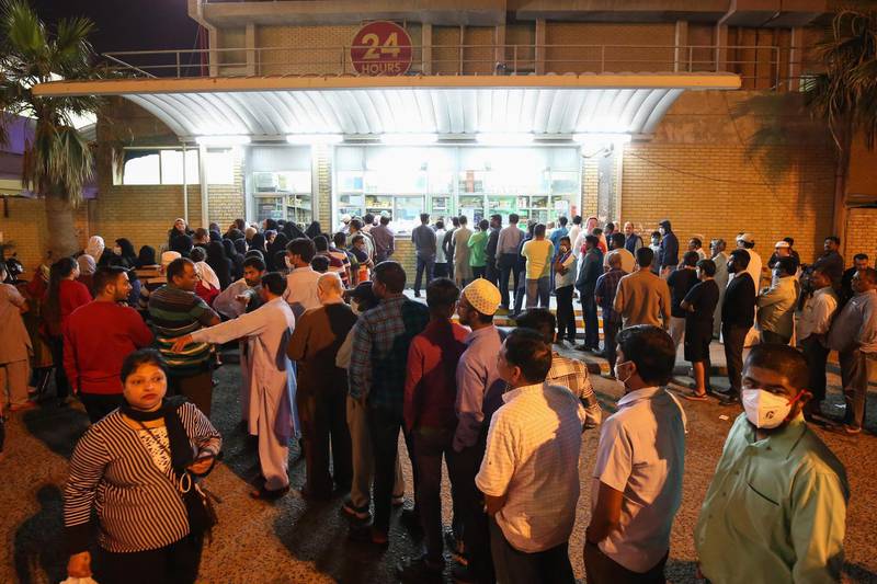 People queue in front of a bakery in Kuwait City .  AFP