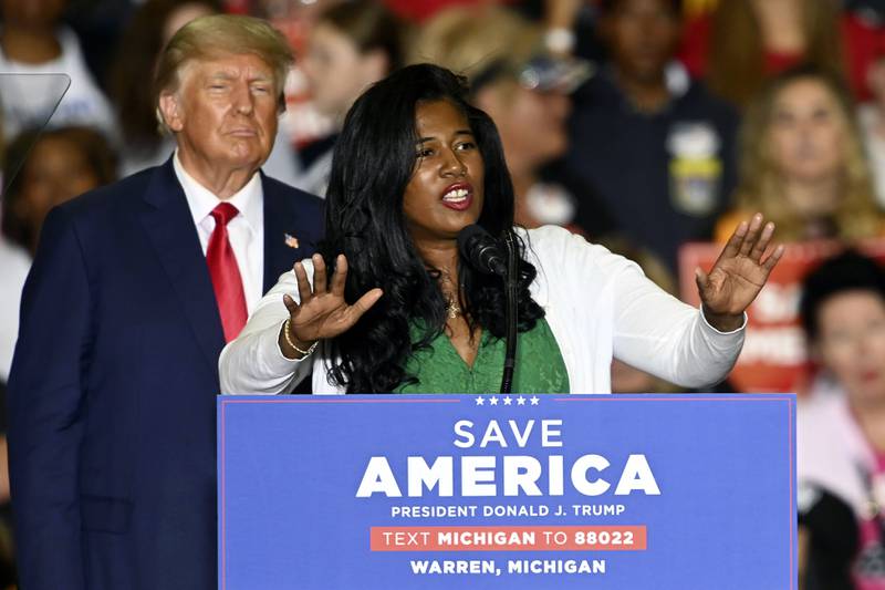 Vociferous election denier Kristina Karamo addresses a rally in Warren, Michigan, as Mr Trump looks on. She has been elected as state party leader. AP