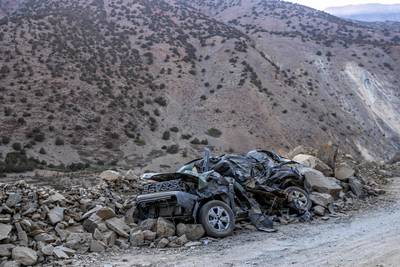A car is crushed by rubble in the aftermath of the earthquake. AFP