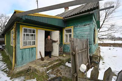 Ukrainian pensioner Lidiya Silina, 87, at her house right next to the border with Belarus. Ms Silina would take the rubbish out on the Belarusian side of the border opposite the twisty stream. Then the troubles started and the Russian tanks came. AFP
