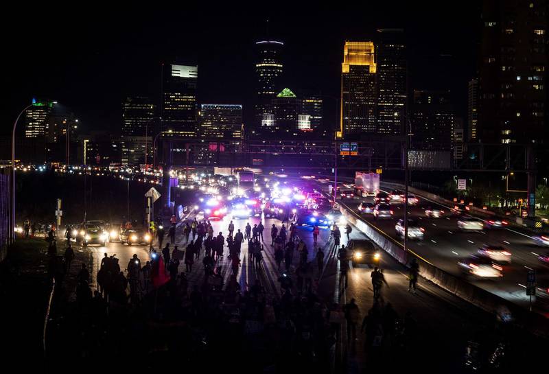 Demonstrators march on to highway I-94 in Minneapolis, Minnesota. AFP