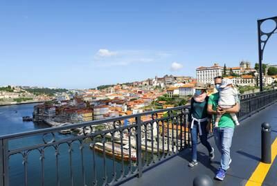 People walk along the Dom Luis I Bridge on the first day that tourists from Britain and most EU countries are allowed to enter Portugal without needing to quarantine, as coronavirus disease (COVID-19) restrictions continue to ease, Porto, Portugal, May 17, 2021. REUTERS/Violeta Santos Moura