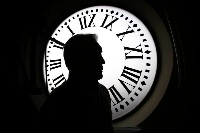 Watchmaker Jesus Lopez-Terradas is silhouetted against one of the clock-faces of the clockwork of the Puerta del Sol tower in Madrid, Spain, 26 December 2022 as it is prepared and checked to give the last twelve rings of the year during the midnight chimes of the clock tower that announces the New Year in the Spanish capital.   EPA / Sergio Perez