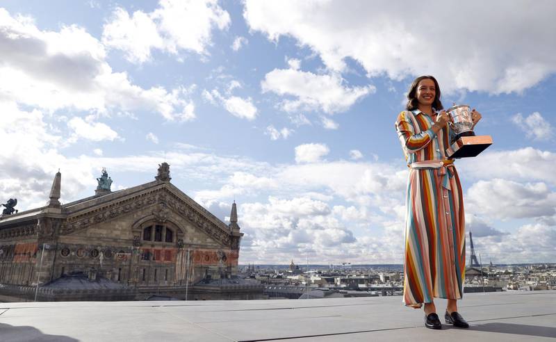 Iga Swiatek of Poland poses with her trophy on the rooftop of the Galerie Lafayette department store. EPA