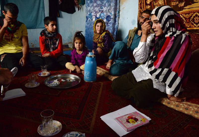 Aziza Rahimzada sits with family members at her temporary home in Kabul.