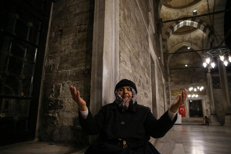 A woman prays during the coronavirus outbreak at the Eyup Sultan Mosque, in Istanbul, Friday, April 3, 2020. After the fifth and final call to prayer of the day in Muslim Turkey, imams around the country have been asked to perform an additional prayer asking for God's mercy and protection during the novel coronavirus pandemic. Calls echoed across the city of Istanbul, Turkey's largest, as thousands of people have been infected with the virus and others have died. (AP Photo/Emrah Gurel)