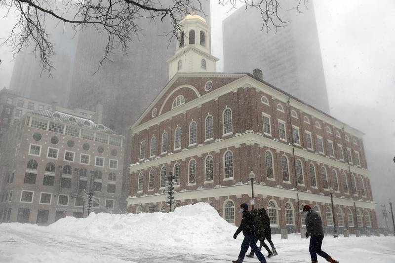 Snow outside Faneuil Hall, in Boston. The storm prompted airlines to cancel about 6,000 flights at the weekend. AP