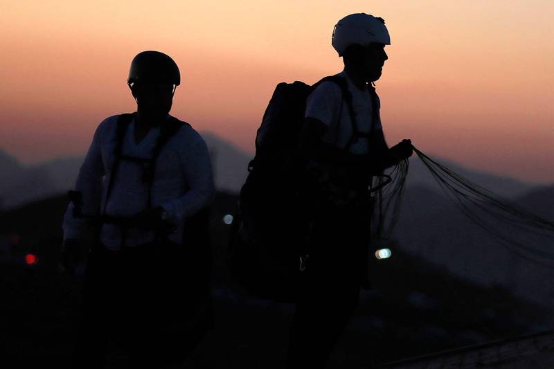 Members of the Sulaymaniyah paragliding team launch at sunset from Mount Azmar to glide over the city of Sulaymaniyah in north-eastern Iraq's autonomous Kurdistan region.