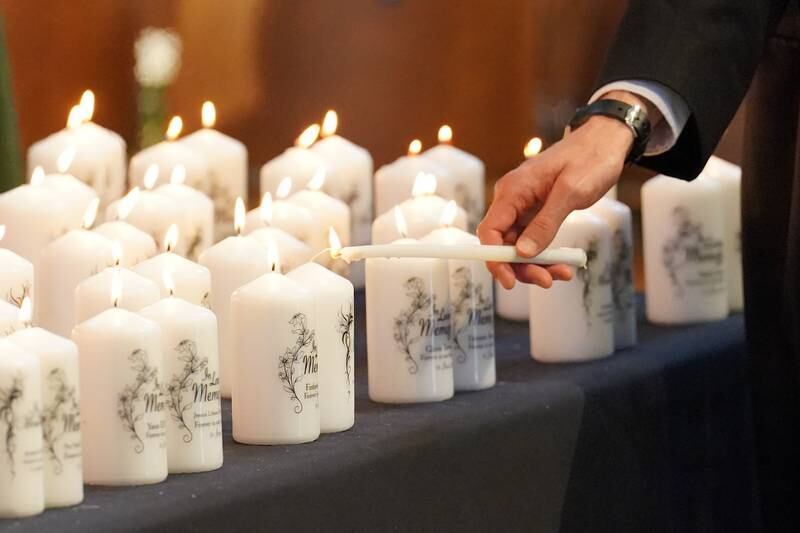 Candles with the names of the victims are lit during the memorial service at Westminster Abbey. Getty Images