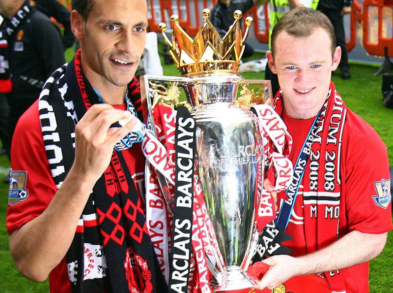 Manchester United players Rio Ferdinand and Wayne Rooney hold the Premier League trophy after their match against Wigan Athletic at The JJB Stadium in Wigan, on May 11, 2008.AFP