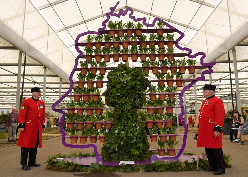 Chelsea Pensioners Ted Fell, left, and George Reid pose as they view 'The Queen's Platinum Jubilee' display by Simon Lycett at Chelsea Flower Show in London. Reuters