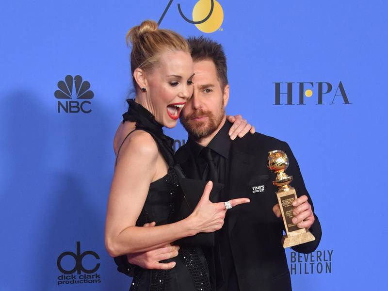 Leslie Bibb poses with actor Sam Rockwell and his award for Best Performance. AFP