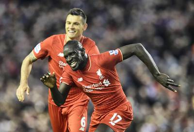 Liverpool's French defender Mamadou Sakho (R) celebrates with Liverpool's Croatian defender Dejan Lovren after scoring during the English Premier League football match between Liverpool and Everton at Anfield in Liverpool, north west England on April 20, 2016. / AFP PHOTO / PAUL ELLIS / RESTRICTED TO EDITORIAL USE. No use with unauthorized audio, video, data, fixture lists, club/league logos or 'live' services. Online in-match use limited to 75 images, no video emulation. No use in betting, games or single club/league/player publications.  / 