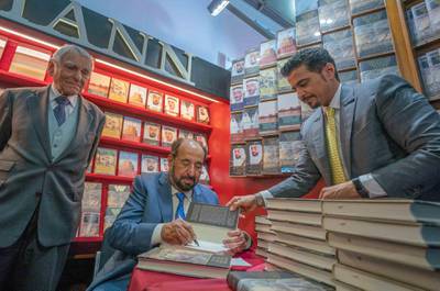 The Ruler of Sharjah, Dr Sheikh Sultan bin Mohammed Al Qasimi, signs book copies during the fair. Courtesy Sharjah Media Corporation