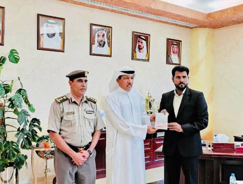 Siddique Pallolathil, Director of Nesto Group, recieves hi gold visa from Brigadier Mohamed Abdullah Alwan, Executive Director of the General Directorate for Residency and Foreigners Affairs, GDRFA, in Ajman. Courtesy Siddique Pallolathil