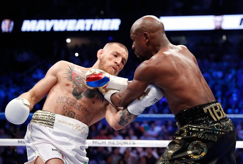 Conor McGregor in action with Floyd Mayweather Jr. Reuters