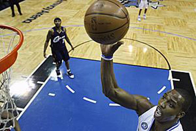 Orlando Magic's Dwight Howard, right, goes to the basket against the Cleveland Cavaliers during the first half.
