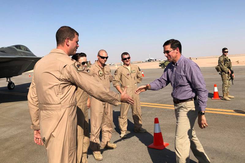 Defense Secretary Mark Esper talks with U.S. troops in front of an F-22 fighter jet deployed to Prince  Sultan Air Base in Saudi Arabia, Tuesday, Oct. 22, 2019.  (AP Photo/Lolita Baldor)