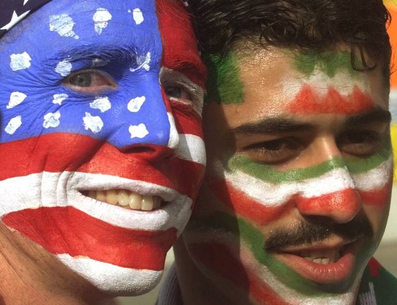 FILE - Mike Moscrop, left, from Orange County, Calif. , poses with Amir Sieidoust, an Iranian supporter living in Holland outside the Gerlain Stadium in Lyon, June 21, 1998, before the start of the USA vs Iran World Cup soccer match.  Iran defeated the U. S.  2-1 for its first World Cup win, eliminating them after just two games.  A rematch between the U. S.  and Iran will be played, Tuesday, Nov.  29, 2022.  (AP Photo / Jerome Delay)