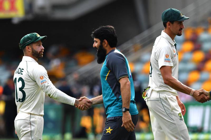 Pakistan's head coach and chief selector Misbah-ul-Haq (C) shakes hand with Australia's Matthew Wade (L) at the end of the first Test. AFP