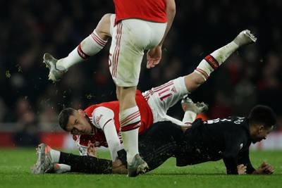 Arsenal's Lucas Torreira, top, clashes with Manchester United's Jesse Lindgard. AP