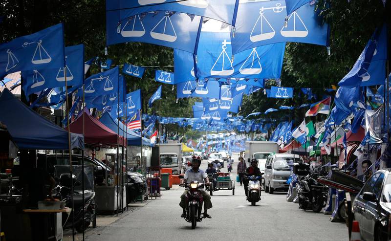 Flags from different political parties are hung along a street in Kuala Lumpur, Malaysia, Monday May 7, 2018. Malaysian scandal-plagued Prime Minister Najib Razak is seeking a third term in office during the May 9 general election, but faces an unprecedented challenge from a rejuvenated opposition led by his former mentor and strongman Mahathir Mohamad. (AP Photo/Aaron Favila)