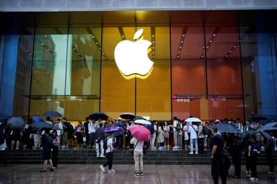 People stand outside an Apple Store in Shanghai. The company is manufacturing its own silicon to reduce its dependence on other suppliers and reduce supply chain friction. Reuters