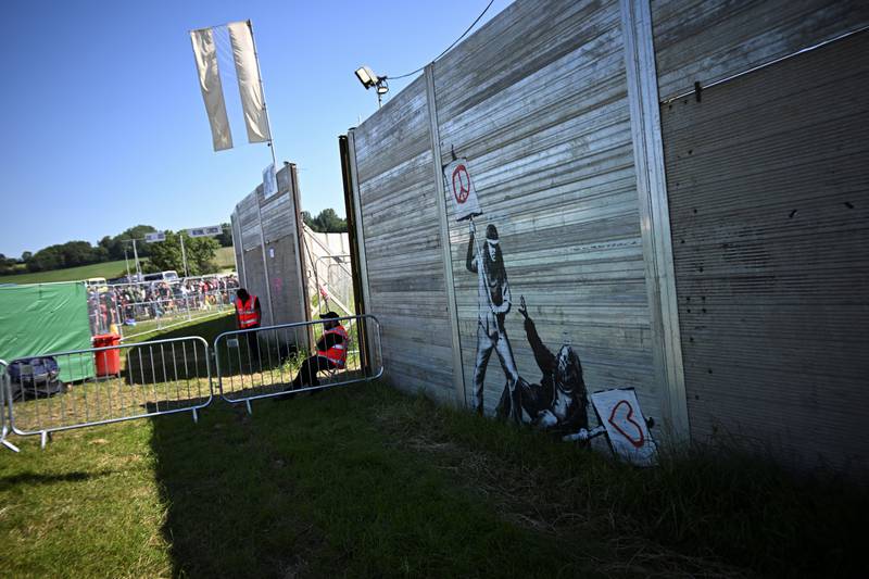 Guards keep watch at the gate as revellers arrive for  Glastonbury Festival at Worthy Farm in Somerset on Wednesday. Reuters