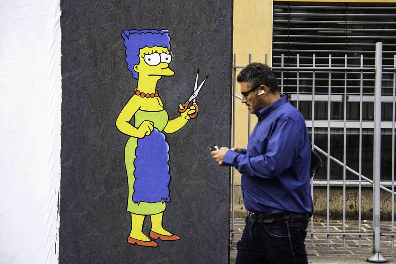 A mural in Milan, Italy, shows Marge Simpson, a character in the animated sitcom 'The Simpsons', cutting her hair in protest over the death of Amini. EPA