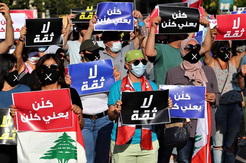 Anti-government demonstrators hold up placards reading in Arabic: 'No trust' during a silent protest in front the government palace in Beirut, Lebanon. EPA