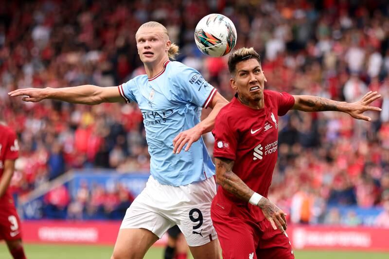 Roberto Firmino of Liverpool battles for possession with Erling Haaland of Manchester City. Getty