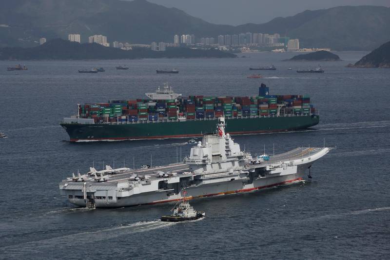 FILE - In this July 7, 2017, file photo, the Liaoning, China's first aircraft carrier, sails into Hong Kong for a port call. Chinese media reports say the country is planning to build a nuclear-powered aircraft carrier capable of remaining at sea for long durations, in what would mark a major upgrade for its increasingly formidable navy. (AP Photo/Kin Cheung, File)