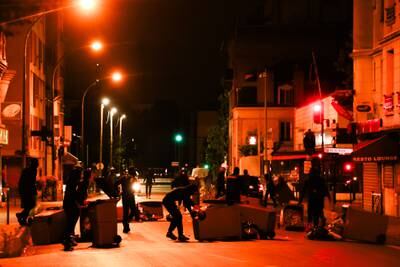 Protesters block a street during during clashes with riot police in Colombes, near Paris.  EPA