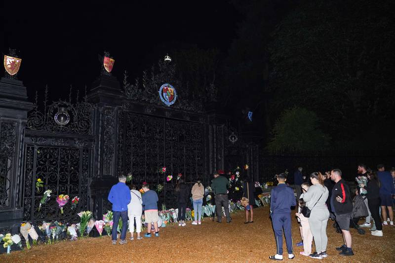 People pay their respects at the gate of Sandringham House in Norfolk. PA