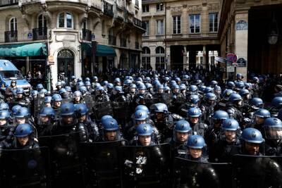 French gendarmes and riot police stand in position in front of the Constitutional Council during a demonstration. Reuters