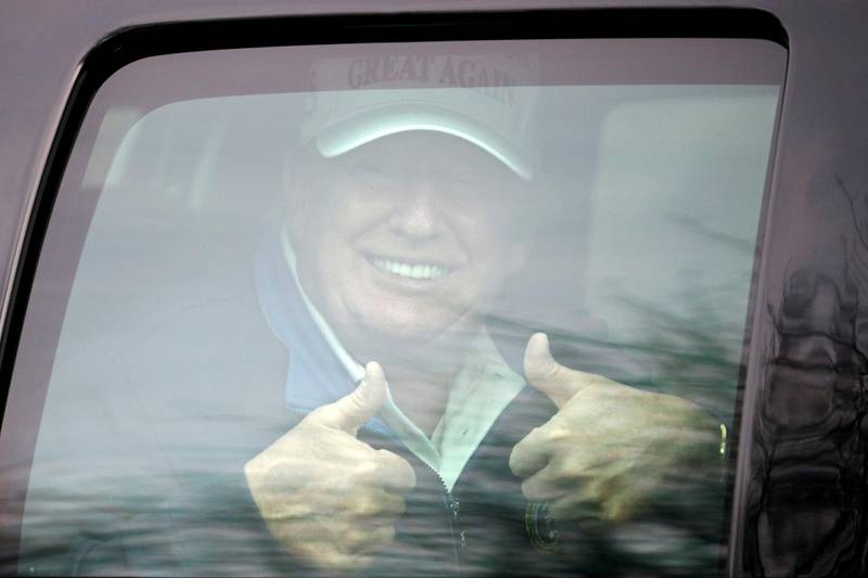 U.S. President Donald Trump gives a thumbs up as his motorcade leaves the Trump National Golf Club in Sterling, Virginia. Reuters