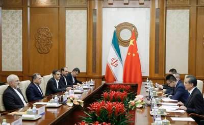 epa06732557 Chinese State Councillor and Foreign Minister Wang Yi (R) meets Iranian Foreign Minister Mohammad Javad Zarif (L) at Diaoyutai state guesthouse in Beijing, China, 13 May 2018.  EPA/THOMAS PETER / POOL