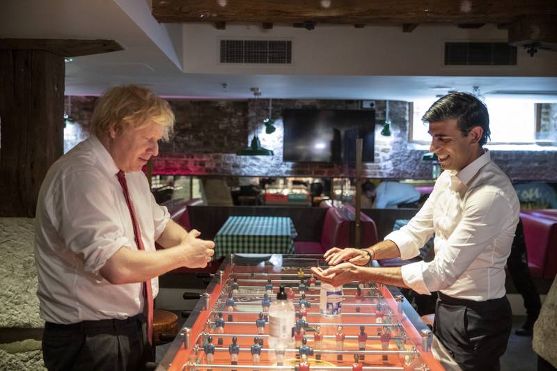 Mr Johnson and former chancellor Rishi Sunak use hand sanitiser during a visit to the Pizza Pilgrims restaurant in June 2020, in east London, to see how they are getting their business ready to reopen as coronavirus lockdown restrictions were lifted in England. PA