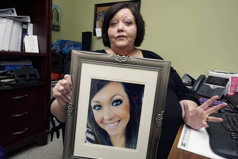 Denise Spears holds a portrait of her late step-daughter Marsha Spears Harbour, a victim of domestic violence, in Meridian, Mississippi, southern US. AP