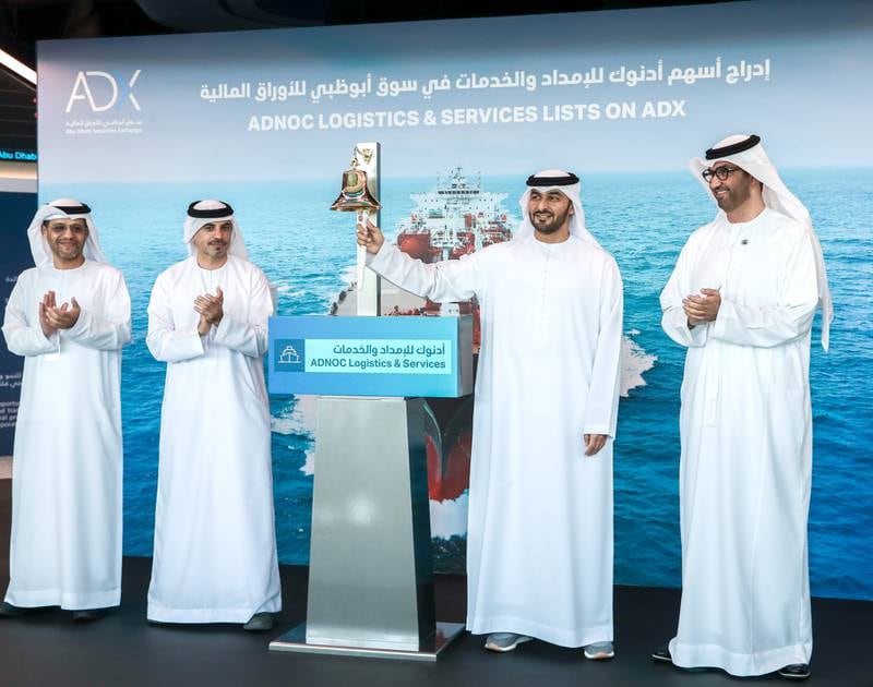 Adnoc L&S chief executive Capt Abdulkareem Al Masabi rings the ADX bell as Dr Sultan Al Jaber, Adnoc managing director and group chief executive, ADX chairman Hisham Malak and bourse chief executive Abdulla Al Nuaimi look on. Victor Besa / The National